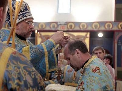Bishop gives his blessing to icons, bestows cross at Brick church