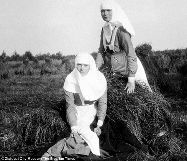 The grand duchesses Olga and Tatiana as sisters of mercy, at the hay-cutting. Pprivate family photo taken in 1916..