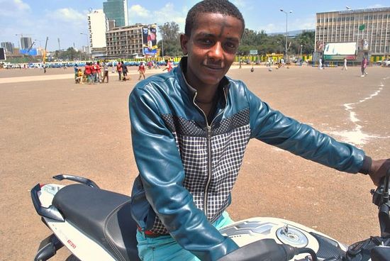 A young man wearing the sign of the cross rides his motorcycle around Meskel Square on Sept. 27, 2013. Photo: IBTimes/Jacey Fortin 