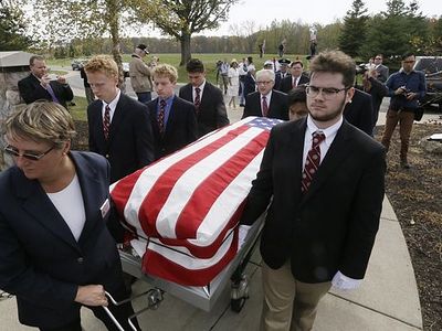 UD Jesuit High students carry caskets of the homeless