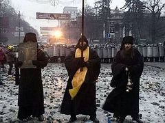 Monks from the Kiev-Caves Lavra stand between police and demonstrators in Kiev