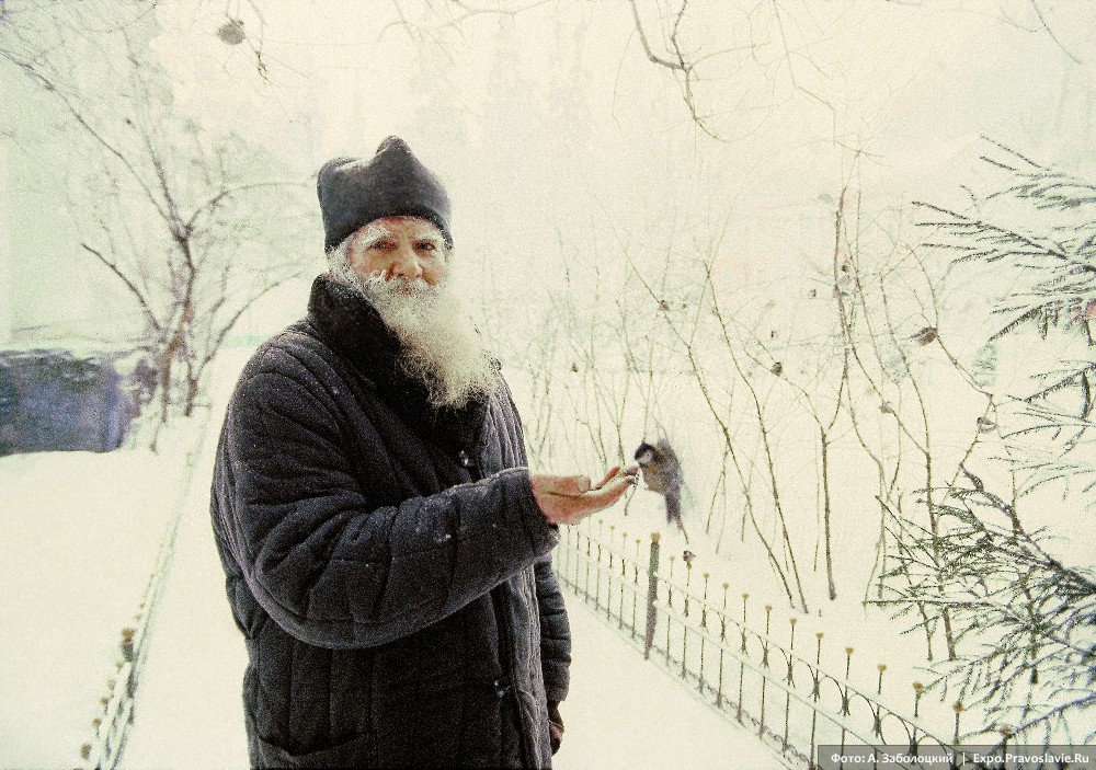 A monk fees a winter bird