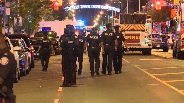 Toronto police officers walk on Danforth Avenue after Sunday's shooting. Photo: Tony Smyth/CBC