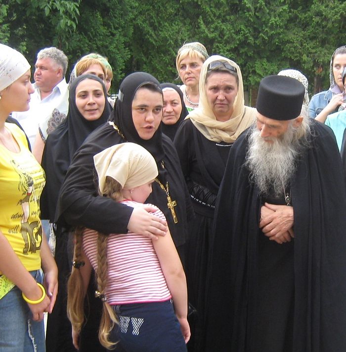 Mother Nonna leads Tamila, daughter of the killed teacher Alena Dzutseva, up to take Elder Iliy’s blessing