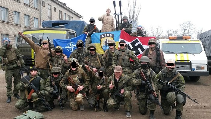 Azov battalion flag in the center beside a swastika and a NATO flag. Photo: Scott.net.