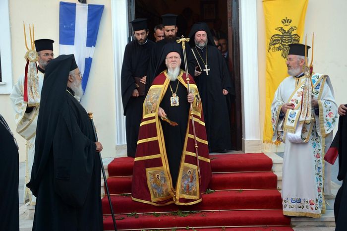 The ecumenical patriarch Bartholomew with the two-headed eagle and Greek flags. Photo: www.amna.gr