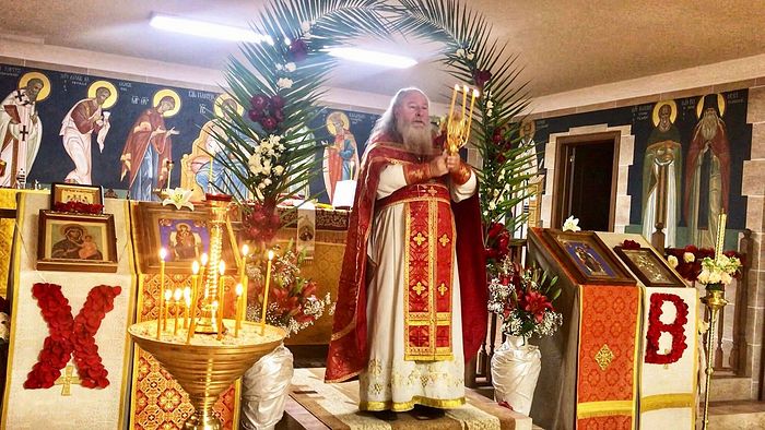 ​Archpriest Alexander serving in the church at the Holy Protection Center