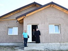 Romanian monastery building house for family with 10 children