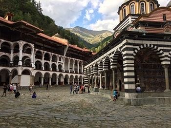 The courtyard of Rila Monastery with a view of Rila Mountain, the highest mountain range in the Balkan Peninsula