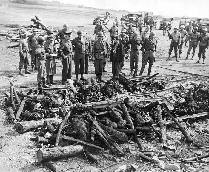 The American generals Patton, Bradly, and Eisenhower at the Ohrdruf concentration camp at the bonfire where the Germans burned the bodies of prisoners