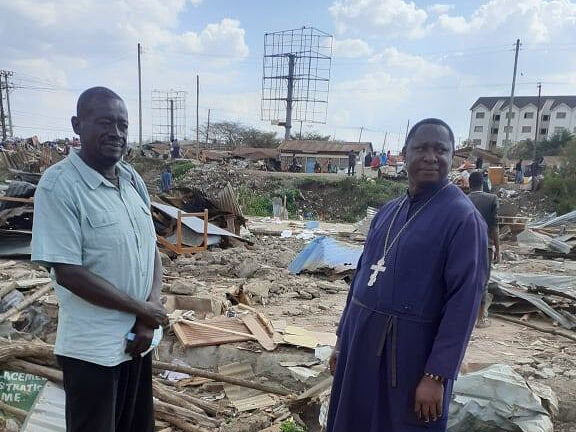 Fr. Antipas amidst the rubble of the school. Photo: Facebook 