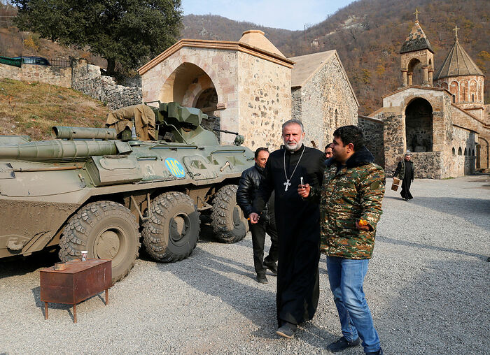 The monastery's abbot Father Hovhannes walks past a military vehicle of the Russian peacekeeping forces at the Dadivank, an Armenian Apostolic Church monastery, located in a territory which is soon to be turned over to Azerbaijan under a peace deal that followed the fighting over the Nagorno-Karabakh region, in the Kalbajar district on Sunday. (Reuters/Stringer)