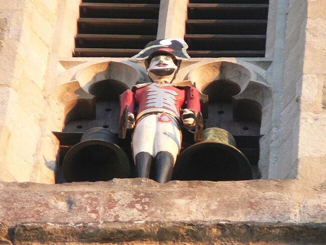 The 'Quarter Jack' painted statue on the west tower of Wemborne Minster Church, Dorset (photo - Wikimedia Commons)