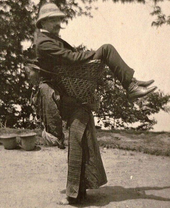 A Sikkim woman carrying a British merchant. West Bengal, 1903.