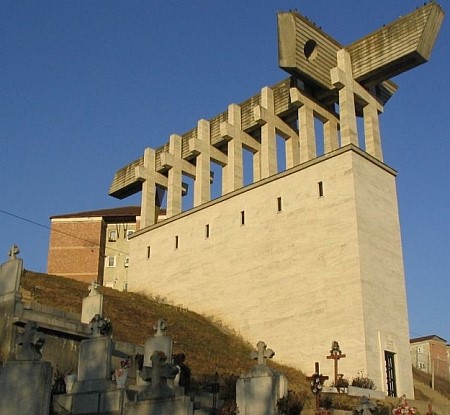 Monument to the victims of Communist prisons. In the background: buildings of Aiud Prison; in the foreground: the Ravine of Slaves; the door at the base of the monument leads to the Skete of the Ascension of the Lord