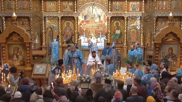 The newly ordained Fr. Nectarios blesses the people following the Liturgy. Photo: YouTube screenshot