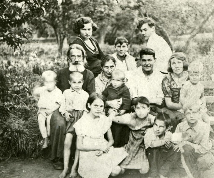 Fr. Alexander and his wife Alexandra with children in the garden